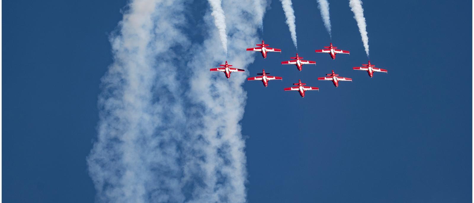 8 jets flying through blue sky